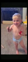 Blond baby with beautiful body wearing diapers