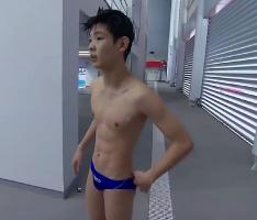 A handsome 14-year-old Vietnamese boy diving from the platform